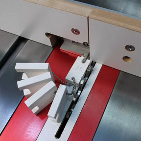 Dado blade set installed in table saw with stacked chipper blades and featherboard guides.