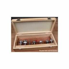 Empty wooden storage box for router bits displayed open on a workbench