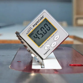Digital angle gauge measuring 45 degrees on a table saw blade for woodworking precision