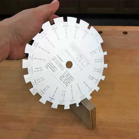 Woodworking dado blade gauge tool with measurement markings on a workbench