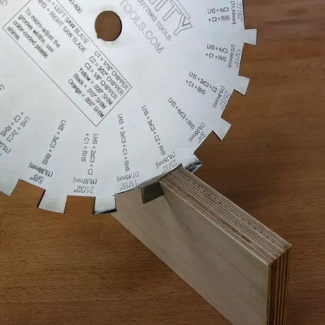 Dado saw blade making a clean groove cut in a plywood board on a wood table