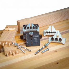 Woodworking dowel jig kit with drill bits and wooden boards on a workbench