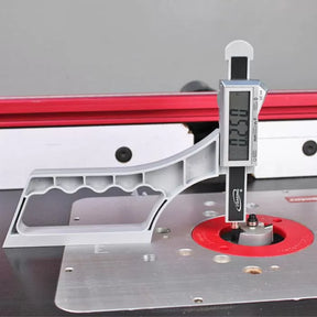 Digital caliper gauge measuring router bit height on a woodworking router table