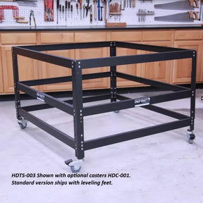 Heavy-duty steel workbench frame with casters in a woodworking shop setting.