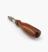 Carpenter's screwdriver with polished wood handle and metal shaft on white background