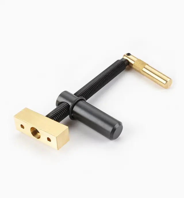 Brass and steel woodworking clamping jig for precision joinery on a white background