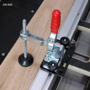 Toggle clamp with red handle securing wood on a router table, woodworking tool setup