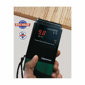 Handheld wood moisture meter displaying 9.8% MC on a plank, woodworking tool shown in use