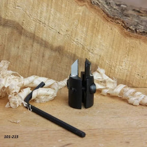 Woodworking plane blade cutter with adjustment tool, set on wood shavings