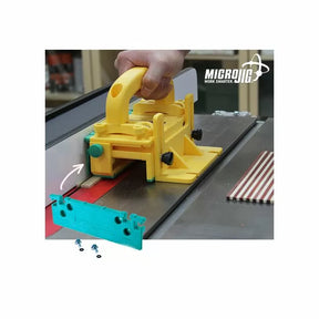 Yellow push block guiding wood on table saw, used for woodworking safety and precision