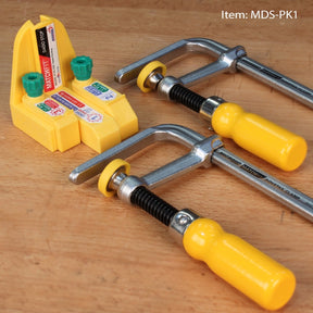 Woodworking dovetail clamps and yellow dado stop on a workbench