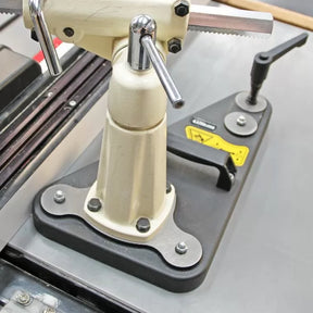 Precision woodworking tool clamp and adjustable saw guide on a workshop table