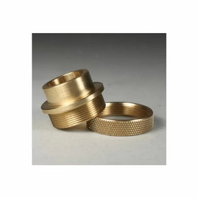 Brass router table insert rings with threaded and knurled finishes on a gray surface