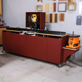 Woodworking miter saw station with storage cabinets and benchtop spindle sander in a workshop