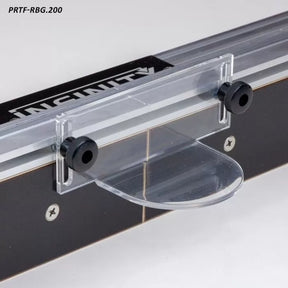 Clear router table safety shield with adjustment knobs mounted on a black fence.