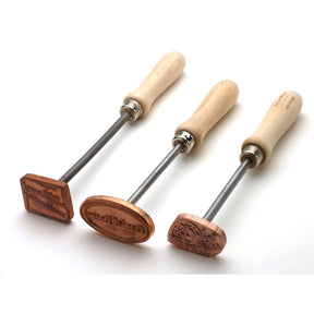 Set of three wood branding irons with wooden handles and engraved brass heads