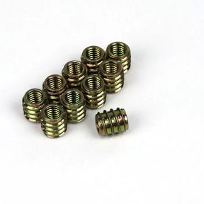 Threaded brass inserts for woodworking on white background, hardware for wood projects