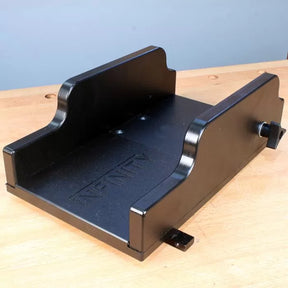Black woodworking sled jig for router table on a wooden workbench