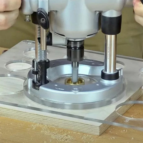 Plunge router on acrylic routing template and wood, woodworking tool in use