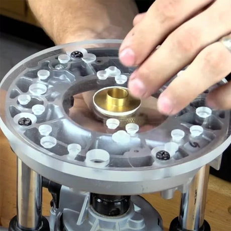 Clear router base plate with brass guide bushing for woodworking tool setup